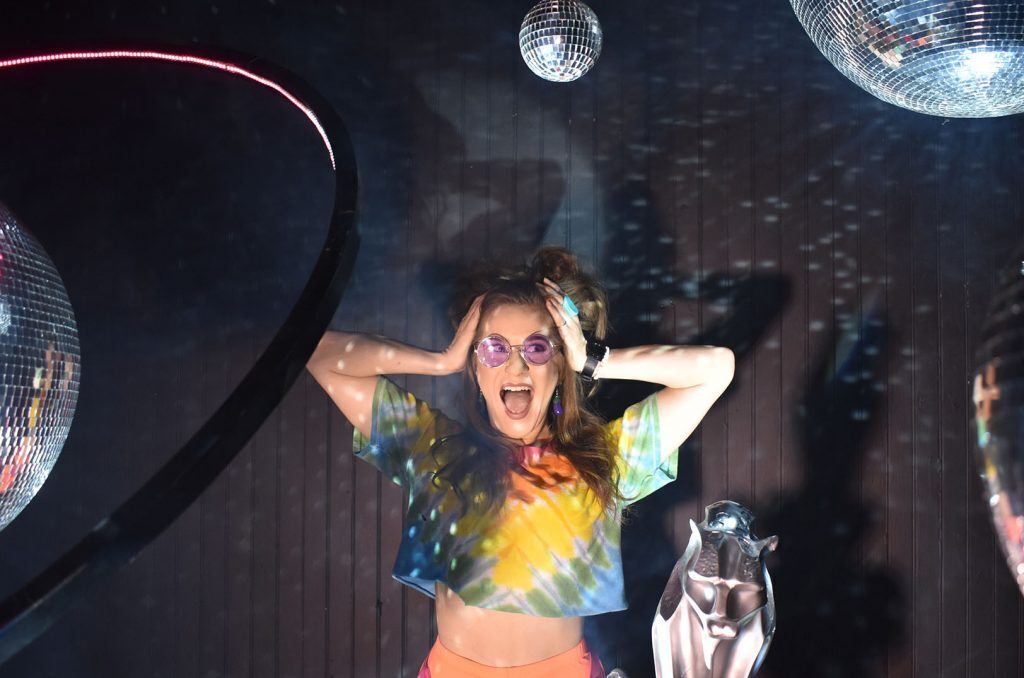 Molly Balloons posing in one of Balloon Wonderland’s backdrops; Art set by Kansas City’s Quixotic