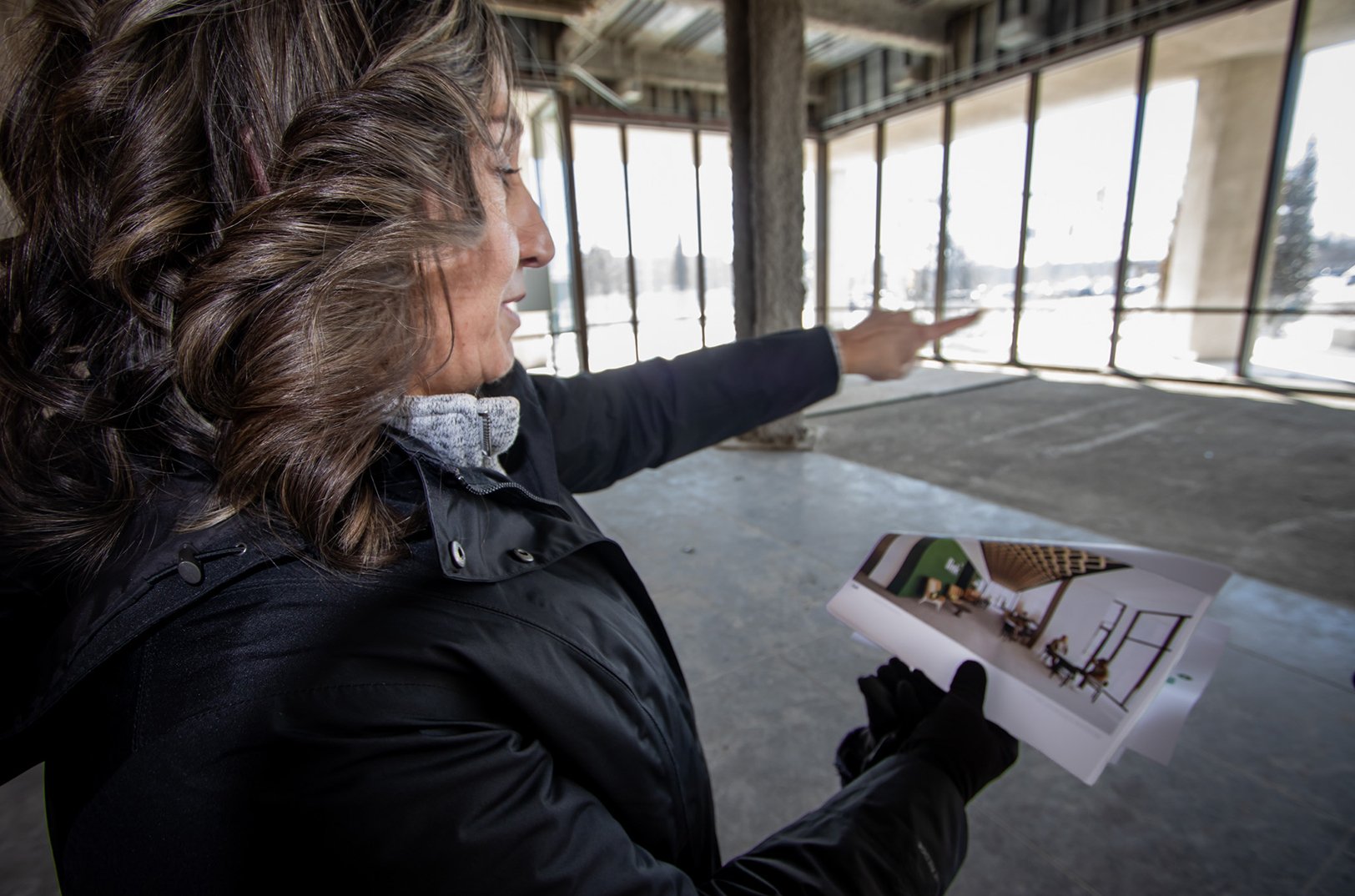 Stephanie Moran, GO Topeka, points out features of a new lobby in the future Link Innovation Labs space in Topeka; photo by Haines Eason