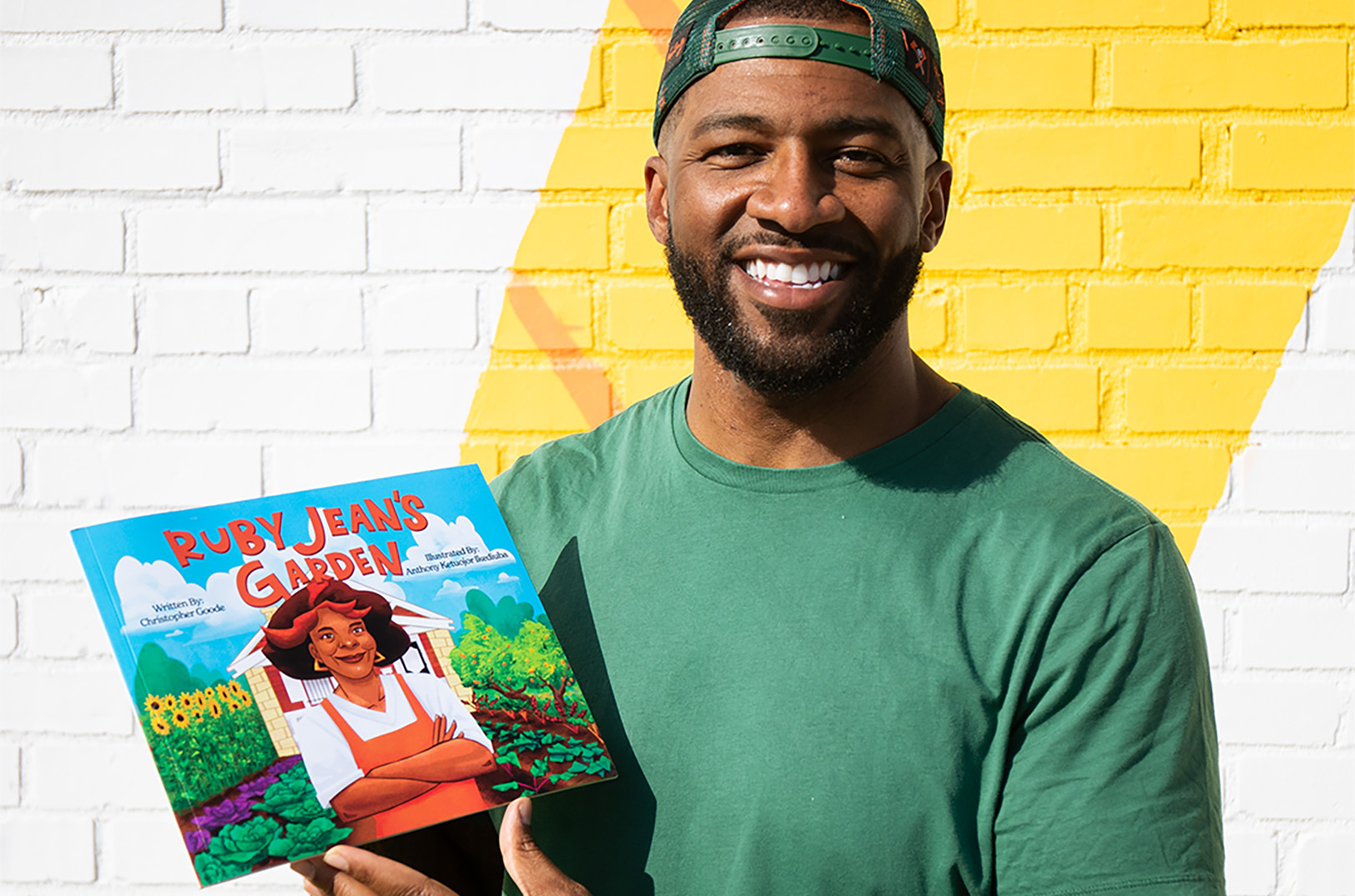 Chris Goode with a copy of the book "Ruby Jean's Garden"; courtesy photo