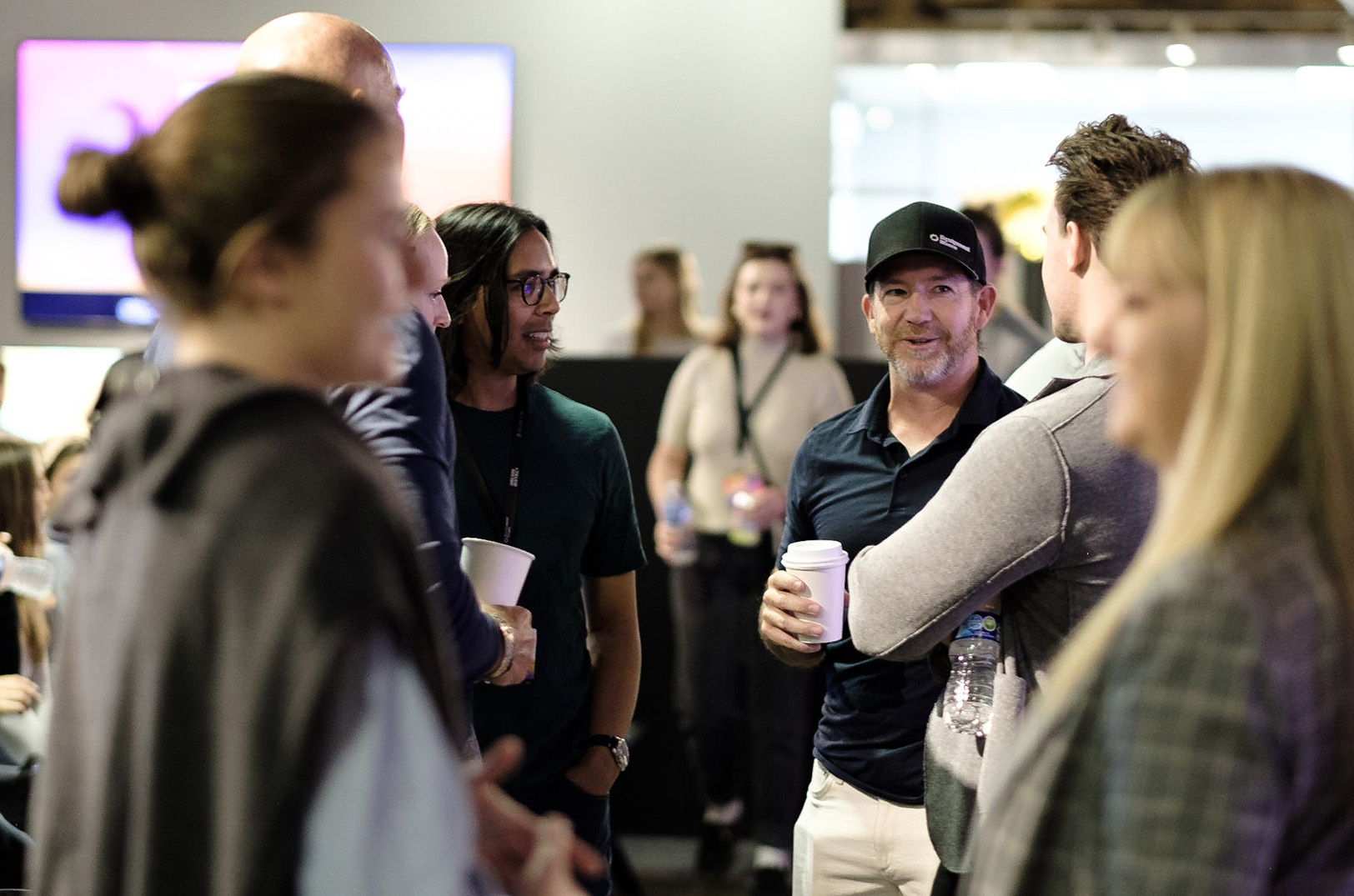 Jabbok Schlacks, co-founder of EquipmentShare, center right, networks at the 2024 Missouri Startup Weekend with Sandy Kemper, founder of C2FO; serial builder Riddhiman Das; Brett Calhoun, general partner at Redbud VC; and others before judging for the Startup Weekend final pitches; photo courtesy of Missouri Startup Weekend