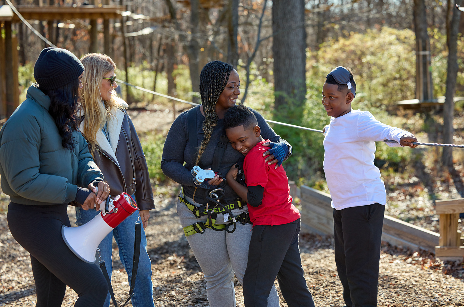 Parenting coach Destini Davis and "The Motherhood" host Connie Britton laugh with Rochelle Owens, center, and her sons Owen and Jacob during filming of "The Motherhood" at Go Ape Zipline & Adventure Park in Kansas City; photo by Matt Hoover, Hallmark