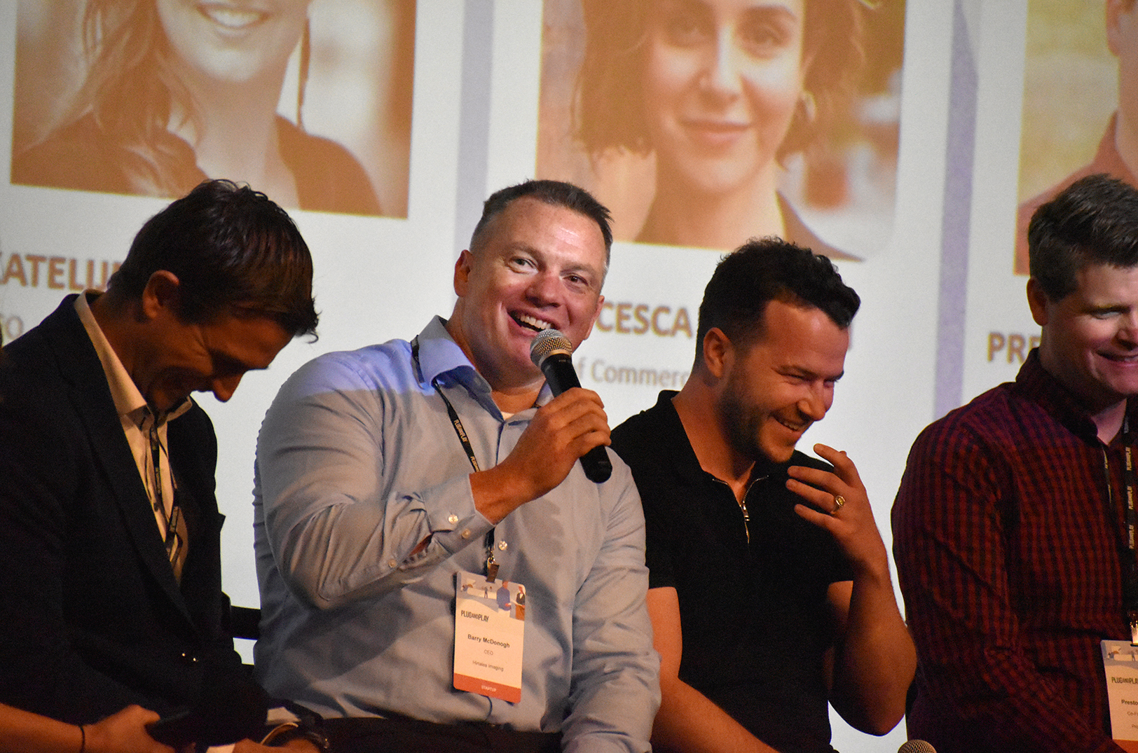 Barry McDonogh, CEO at Hinalea Imaging, center, shares a laugh with fellow Plug and Play Topeka cohort members on stage during the accelerator's Expo Day; photo by Nikki Overfelt Chifalu, Startland News