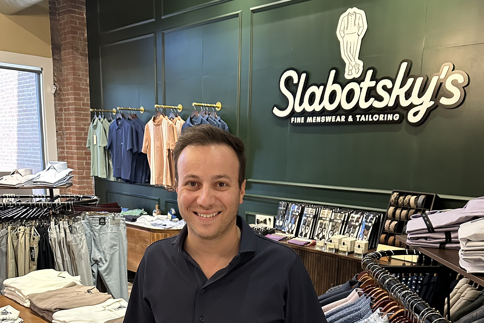 Michael Jerwick, owner of Slabotsky’s Fine Mens Wear and Tailoring and co-founder of GH Monday, at the 306 Delaware St. shop in River Market; photo by Joyce Smith