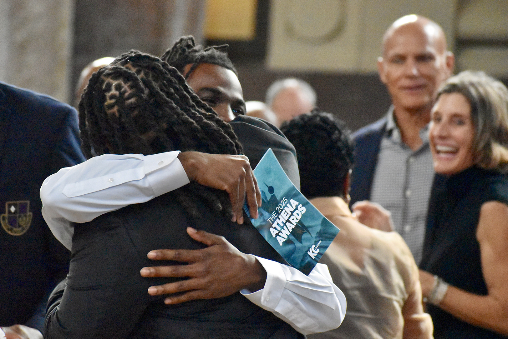 DePrice Taylor, community relations executive director for the Kansas City Current — and winner of the ATHENA Young Professional Leadership Award — embraces one of her mentees during the KC Chamber's 2025 ATHENA Awards at Union Station; photo by Nikki Overfelt Chifalu, Startland News