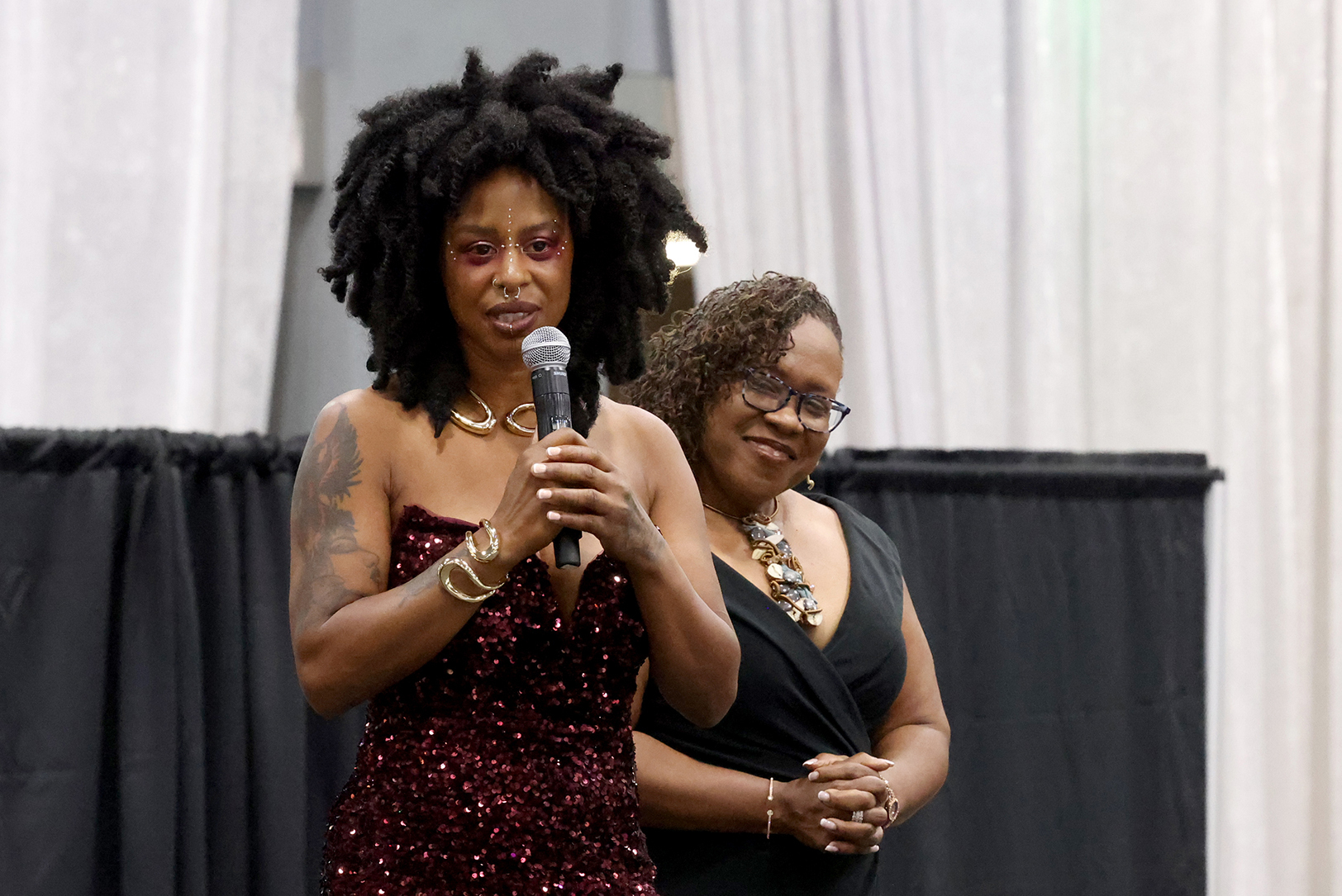 Tanyech Yarbrough, founder and CEO of Wah Gwan Afro Caribbean restaurant, accepts KC GIFT's $100,000 grant during the nonprofit's annual gala as Dr. DeAngela Burns Wallace, president and CEO of the Ewing Marion Kauffman Foundation, looks on; photo courtesy of KC GIFT