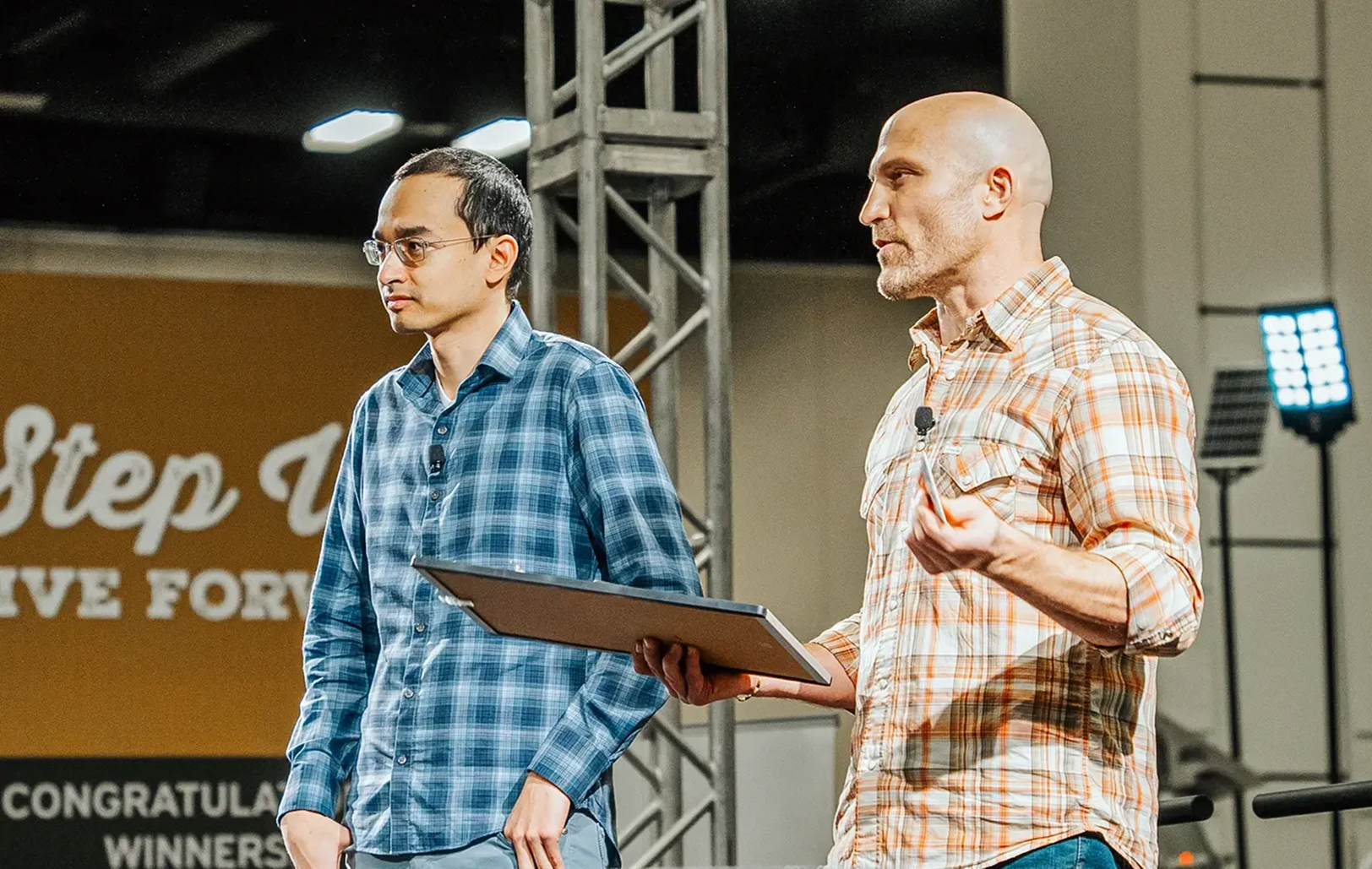 Gripp co-founders Jenkin Lee and Tracey Wiedmeyer on stage speaking about their startup; photo courtesy of Gripp