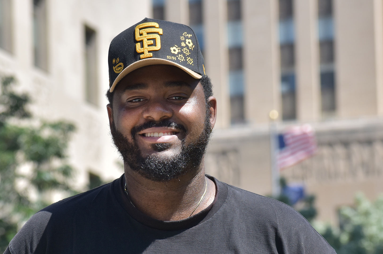 Mychal Shaw, founder and CEO of Uwazi.AI, stands in front of City Hall in downtown Kansas City; photo by Tommy Felts, Startland News