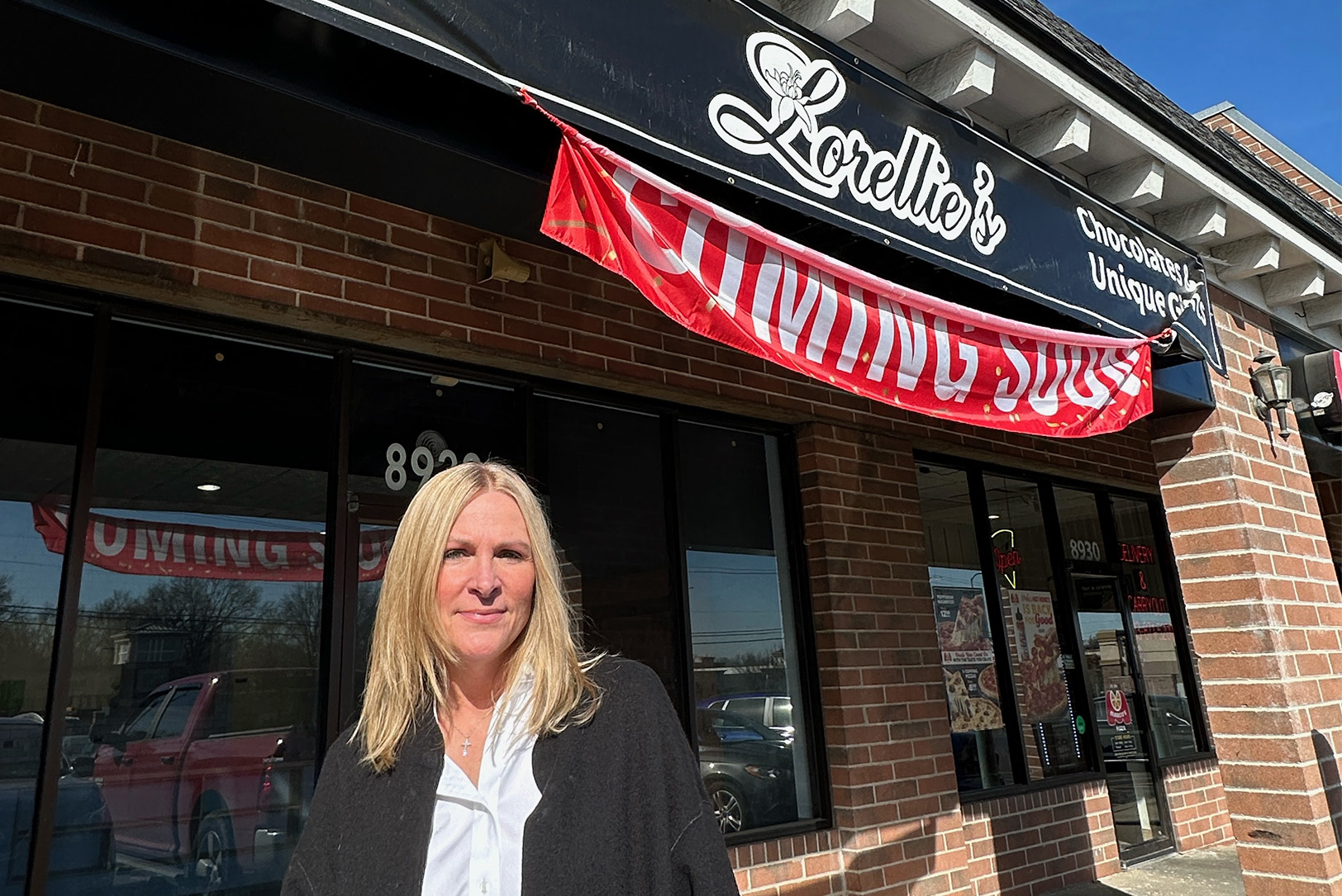 Brandi Robertson stands outside the new Lorellie’s Handcrafted Caramels and Chocolates candy shop at at 8932 W. 95th St. in Overland Park; photo by Joyce Smith
