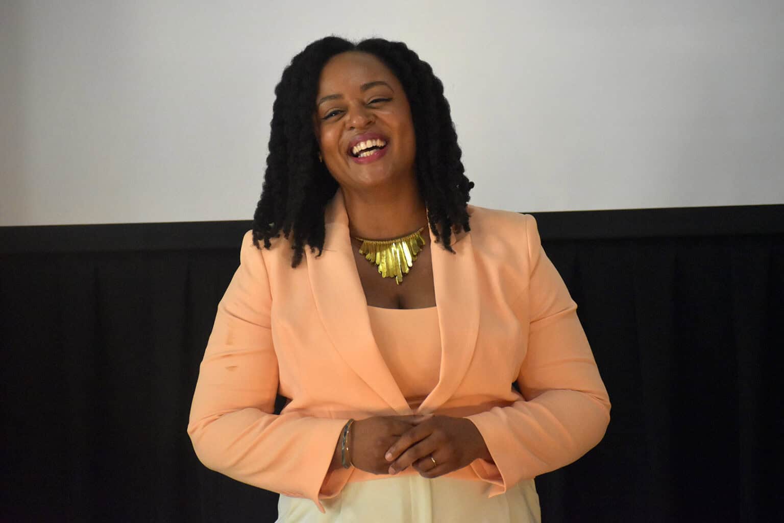 KC GIFT pitch competition winner smiling on stage, celebrating innovation and teamwork.