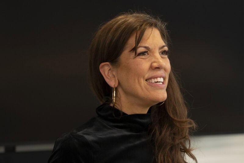 Woman smiling at a conference, representing Kauffman-funded entrepreneurial projects.