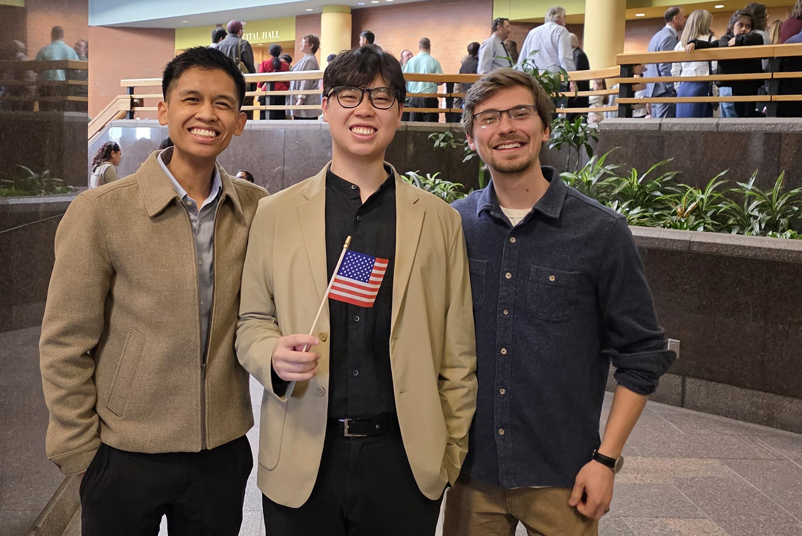 Warren Wang, center, stands with Kenneth Bautista, chief of staff for Rebulk, and Cole Robertson, co-founder of Rebulk, outside Wang's recent naturalization ceremony to become a U.S. citizen; courtesy photo