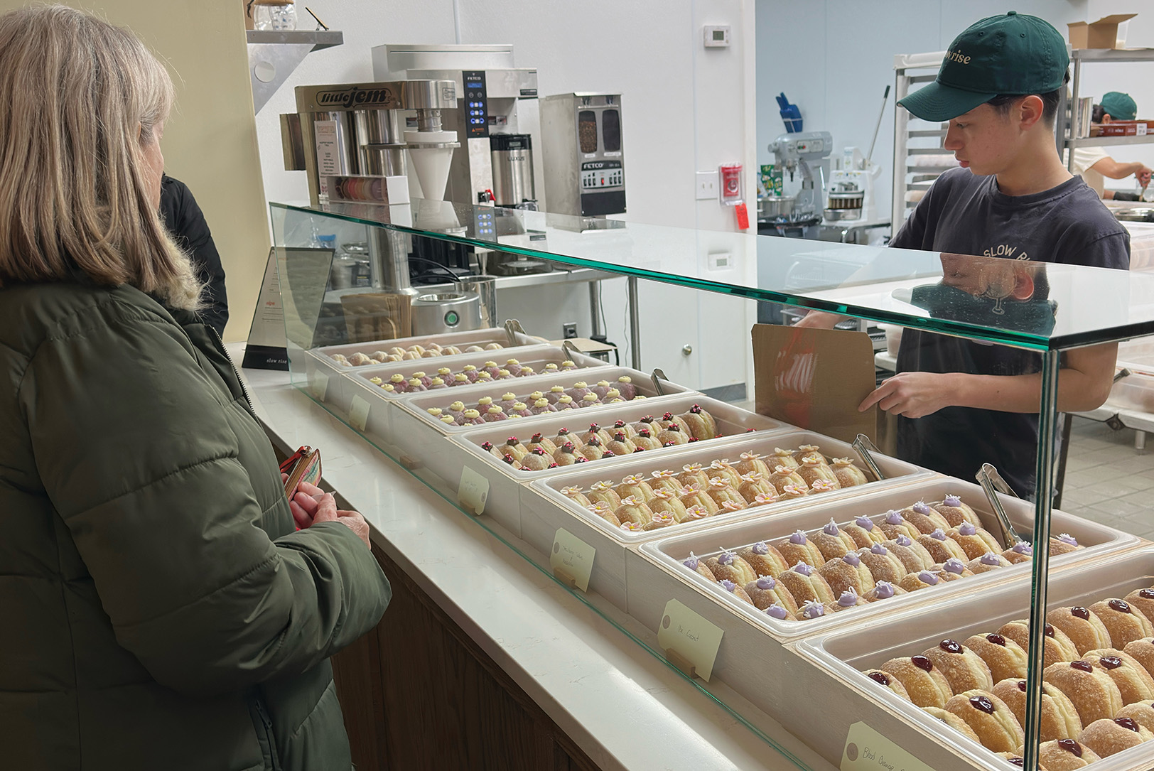Customers order sourdough doughnuts from Slow Rise in Overland Park; photo by Joyce Smith
