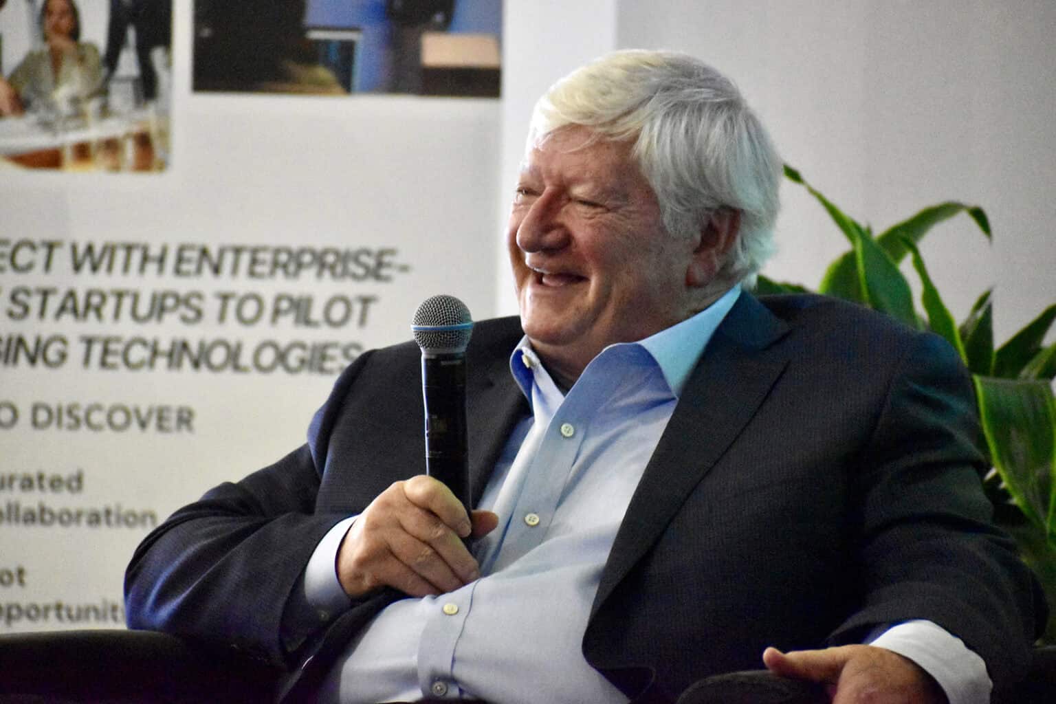 Cliff Illig, co-founder of Cerner and longtime Sporting KC owner, smiles on stage at Keystone CoLabs; photo by Nikki Overfelt Chifalu, Startland News