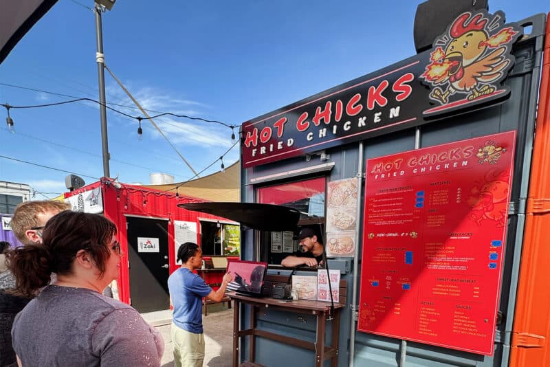 Obida Abu-Zareefeh serves Hot Chicks customers at Iron District in North Kansas City; photo by Joyce Smith