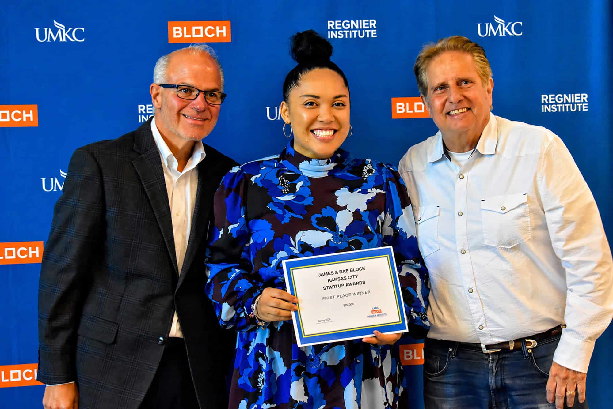 Antoinette Redmond, founder of Neuru, center, accepts the first place award in the James and Rae Block Kansas City Community Startup Awards track from Jeff Hornsby, executive director of the Regnier Institute for Entrepreneurship and Innovation at the University of Missouri-Kansas City, and David Block, president of Block & Company; photo by Taylor Wilmore, Startland News