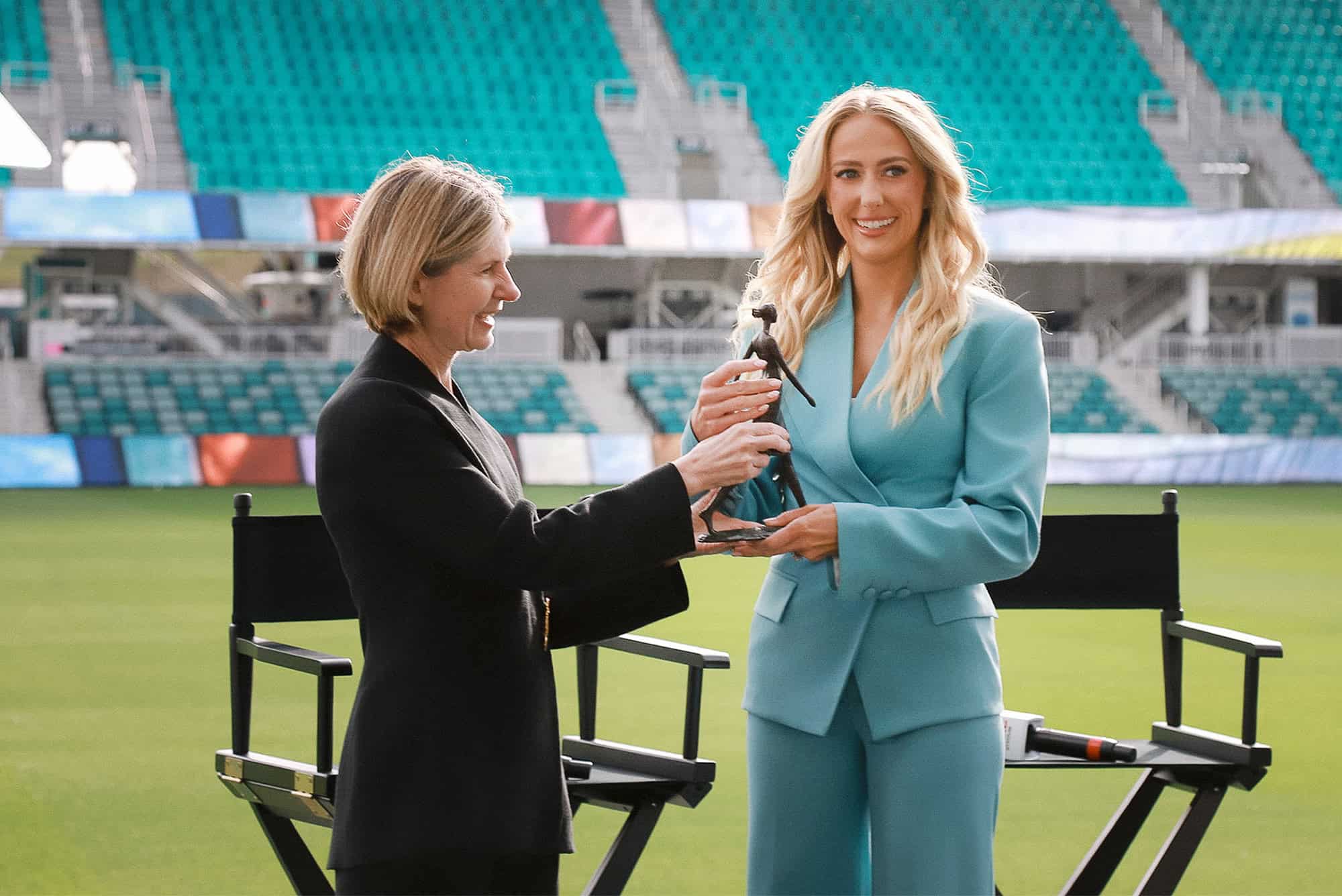 Wendy Doyle, president and CEO of United WE, presents Brittany Mahomes with the 2026 Champions for Change Award during a United WE celebration event at CPKC Stadium; photo by Samantha Levi Photography