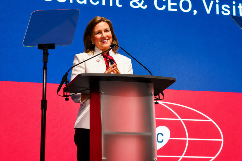 Kathy Nelson, president and CEO of Visit KC, smiles on stage at Municipal Auditorium during Visit KC's Annual Tourism Outlook event; photo by Nikki Overfelt Chifalu, Startland News