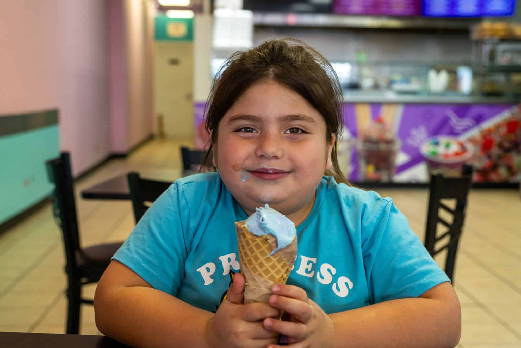 Yazmine Guerrero, 7, of St. Joseph, Missouri, enjoyed a bubblegum ice cream waffle cone recently at Frutopia, located at 3737 Independence Avenue in Kansas City, Missouri. Frutopia is a Mexican paleteria, ice cream shop, and grill; photo by Todd Feeback, Flatland
