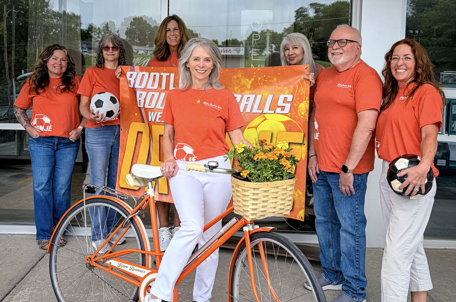 Lisa Fitch, center, and the Bootleg Bourbon Balls team decked out in orange ahead of the Netherlands vs Tunisia game in Kansas City; courtesy photo