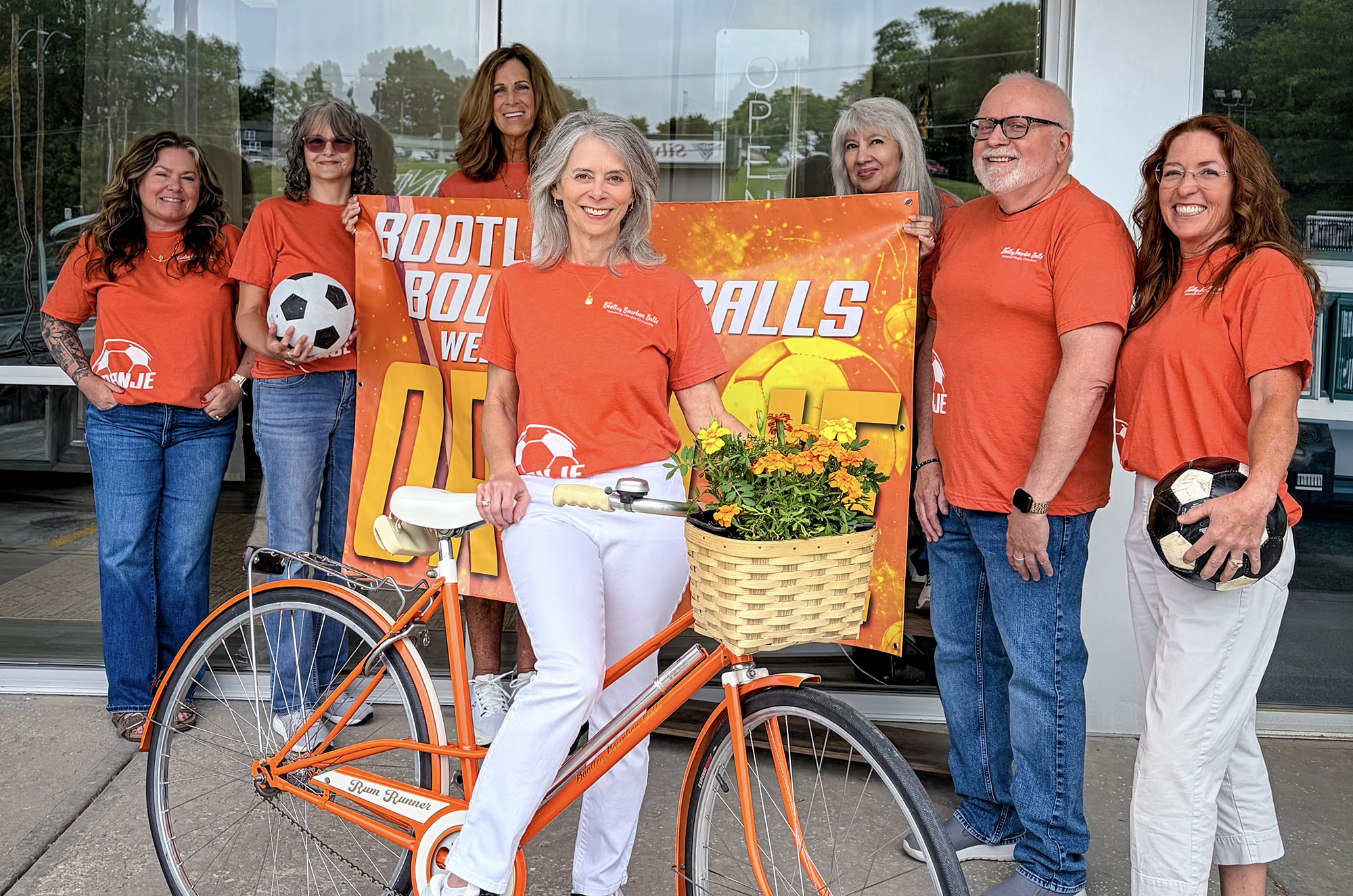 Lisa Fitch, center, and the Bootleg Bourbon Balls team decked out in orange ahead of the Netherlands vs Tunisia game in Kansas City; courtesy photo