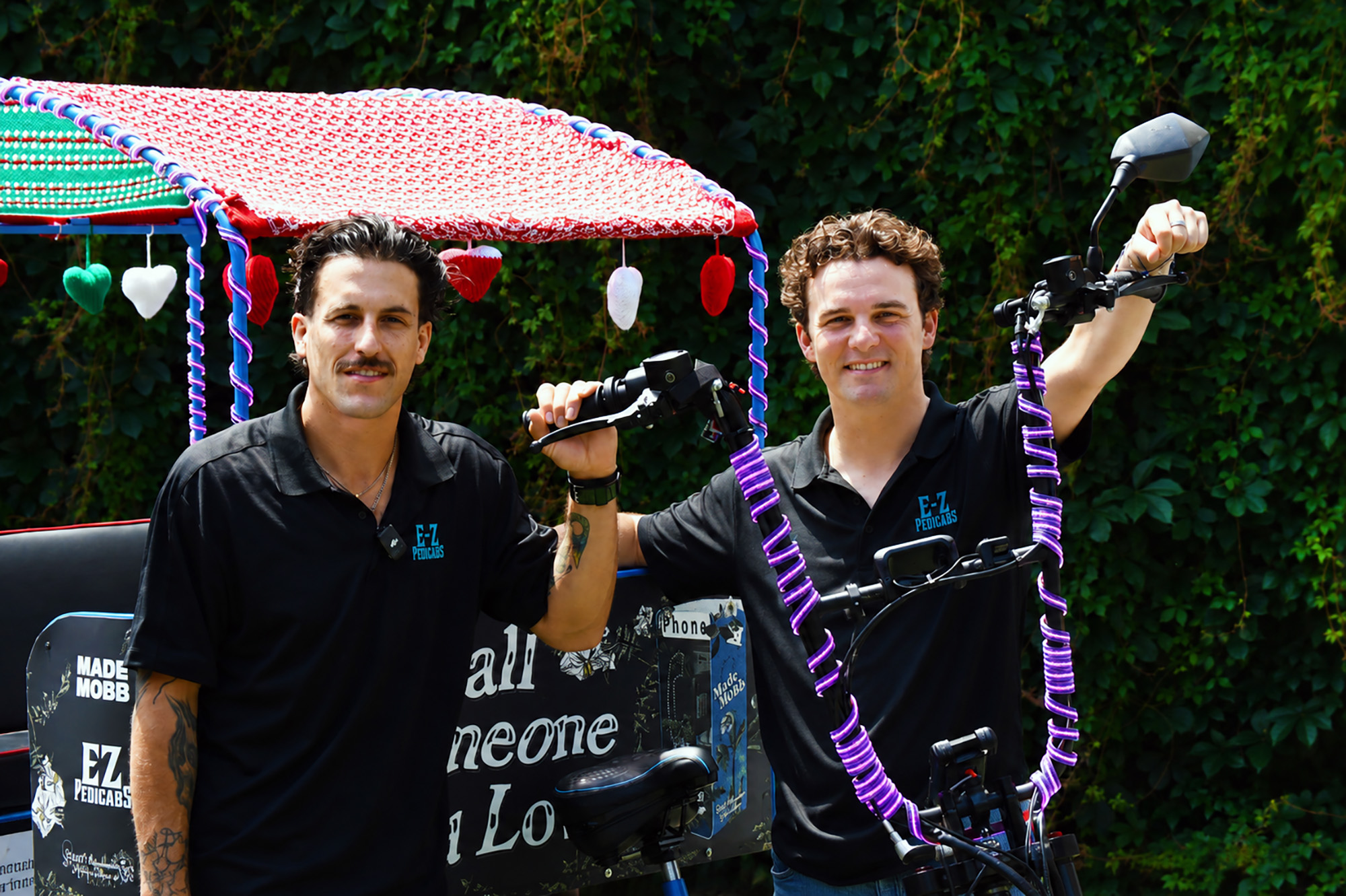 E-Z Pedicabs co-founders Atticus Sloan and Mark Manning stand with a pedicab near their original Westside shop; photo by Tommy Felts, Startland News