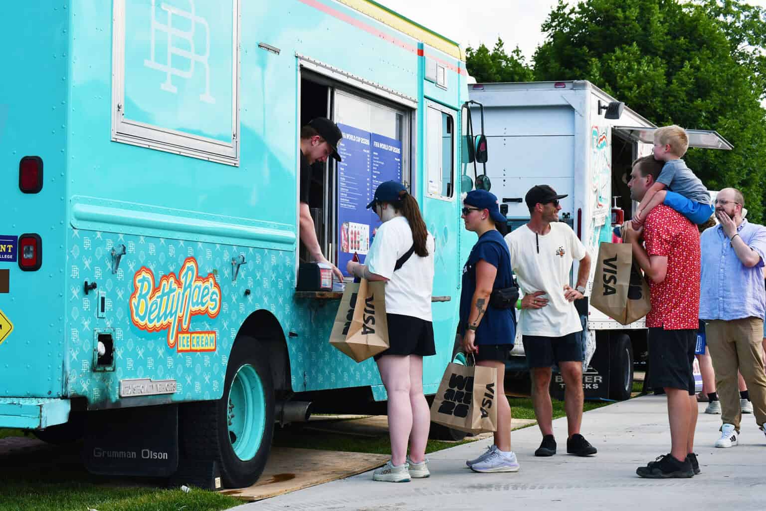 FIFA Fan Festival preview attendees sample food from trucks parked on the grounds of Liberty Memorial; photo by Tommy Felts, Startland News
