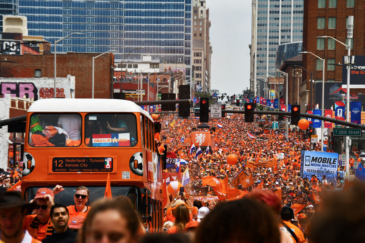 Throngs of Oranje Army fans backing Team Netherlands in the FIFA World Cup march in a fanwalk south down Grand Avenue in Kansas City; photo by Tommy Felts, Startland News