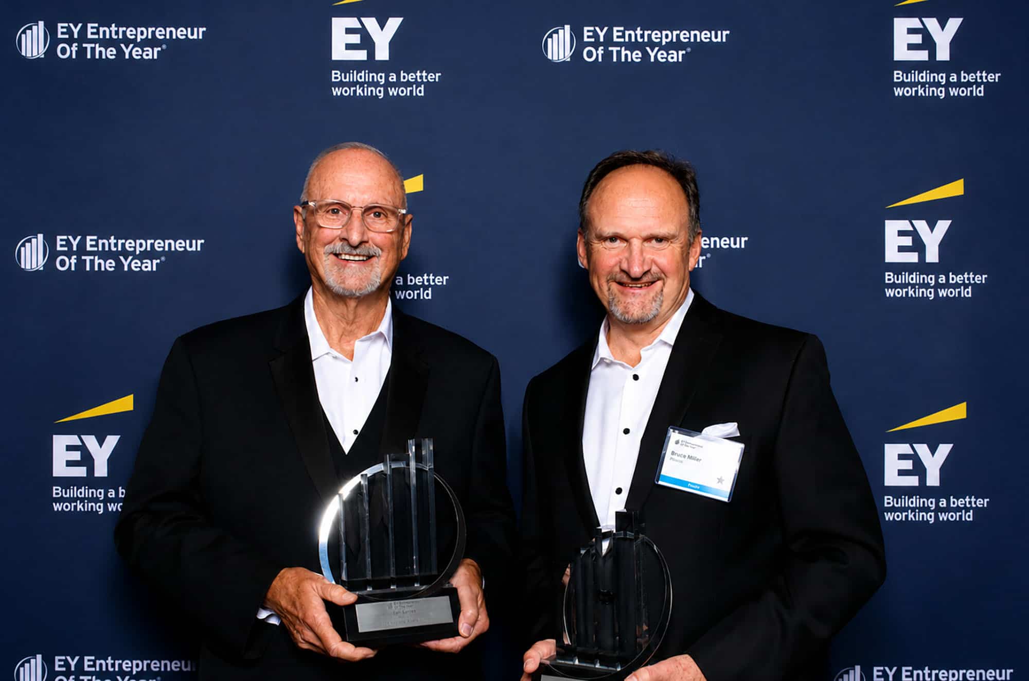 Earl Santee, founder and chairman emeritus of Populous, and Bruce Miller, CEO and global chair, accept the 2026 EY Entrepreneur Of The Year Heartland Award; photo courtesy of Populous