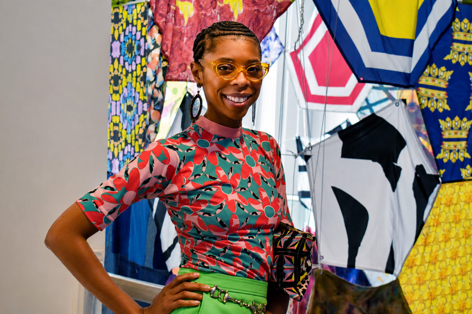 Whitney Manney, founder of the creative brand WHITNEYMANNEY (WM), stands next to her large-scale tapestry installation inside KC•House on the Country Club Plaza; photo by Taylor Wilmore, Startland News