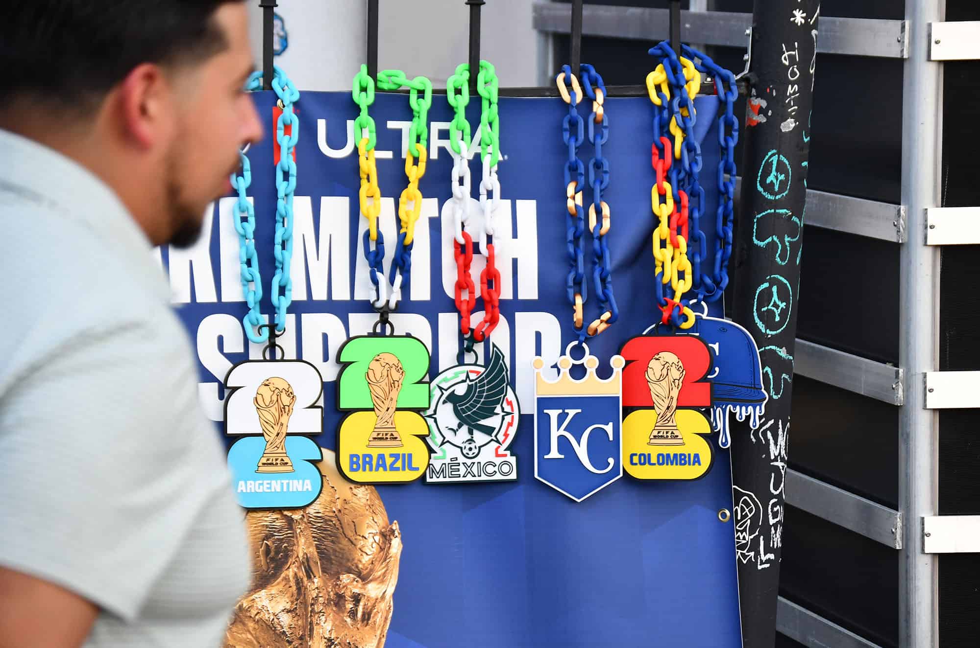Non-licensed, 3D-printed World Cup-inspired chains hang for sale on fence along Southwest Boulevard during First Fridays in Kansas City's Crossroads Arts District; photo by Tommy Felts, Startland News
