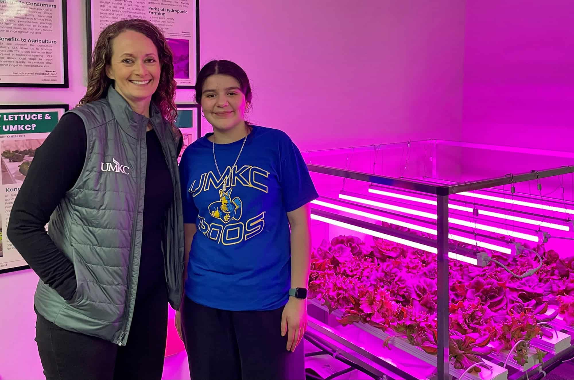 Angela Cottrell, Ed.D., director of research and institutional programs at UMKC, and Jackie Gildo, a junior at UMKC, stand near a hydroponic lettuce growing system; courtesy photo