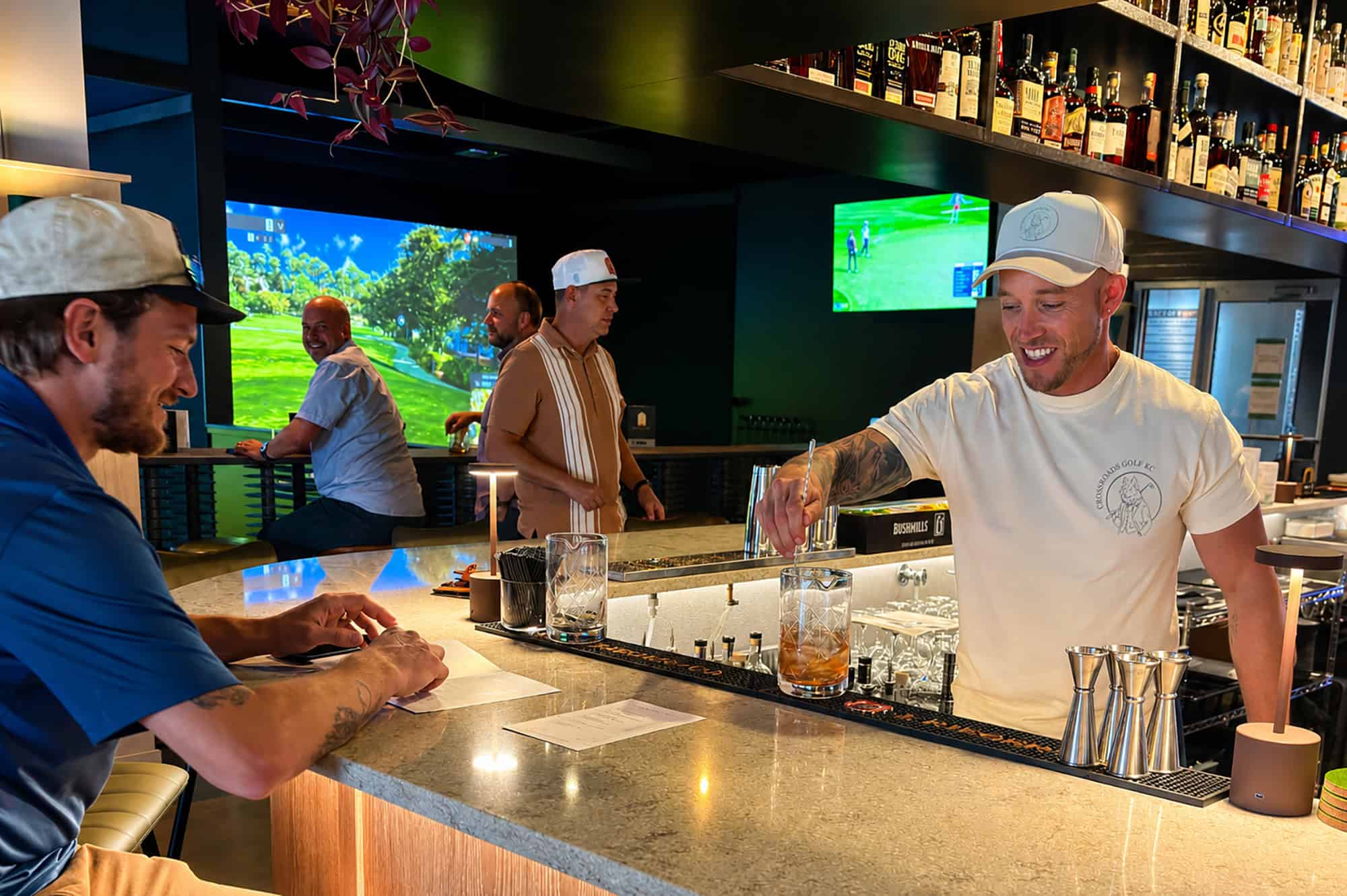 Bartender Kevin Kraft serves a cocktail during a soft opening for Crossroads Golf at 1656 Washington St., Suite 100; photo by Joyce Smith