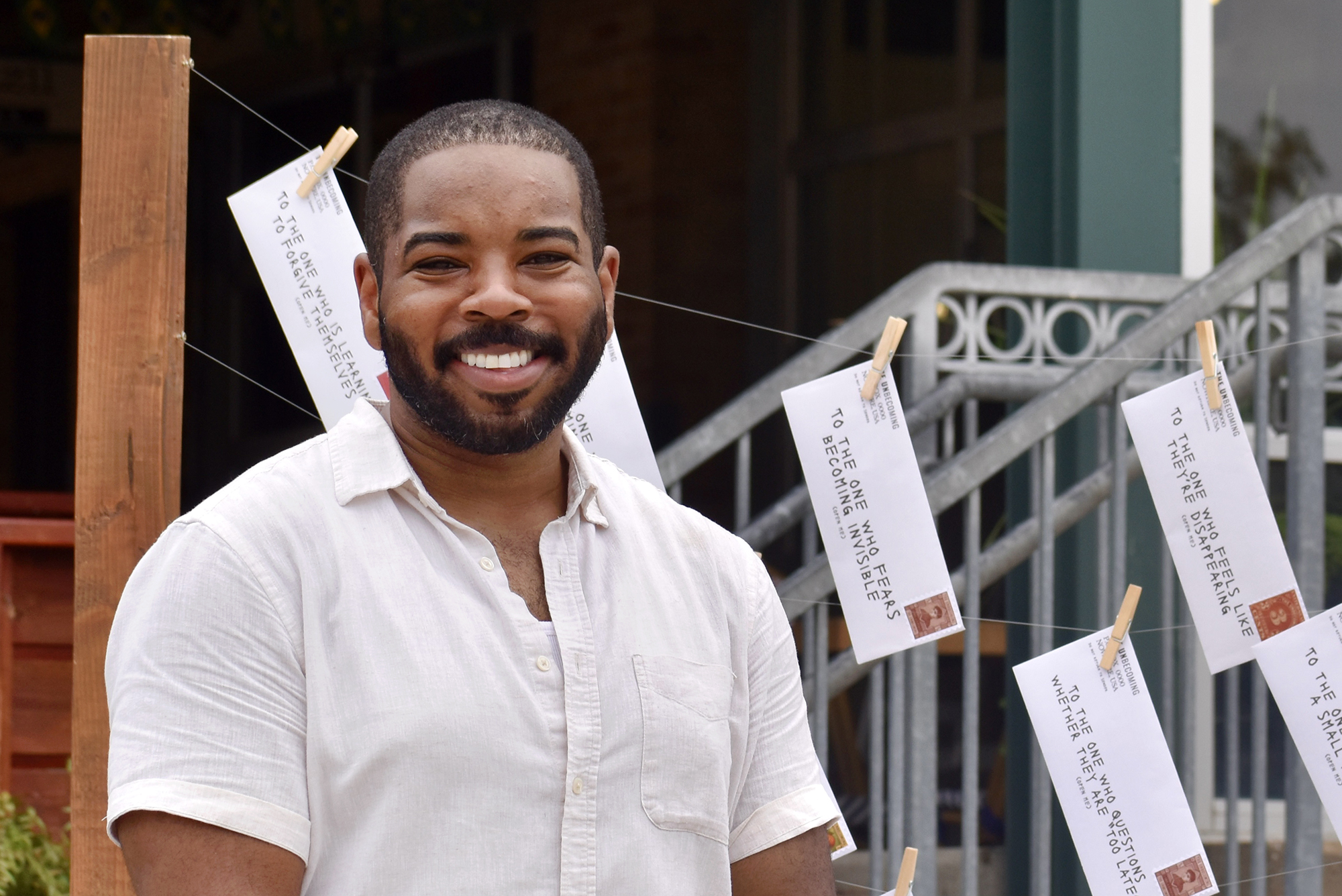 Kasim Hardaway stands with his Take What You Need interactive installation at City Market; photo by Nikki Overfelt Chifalu, Startland News