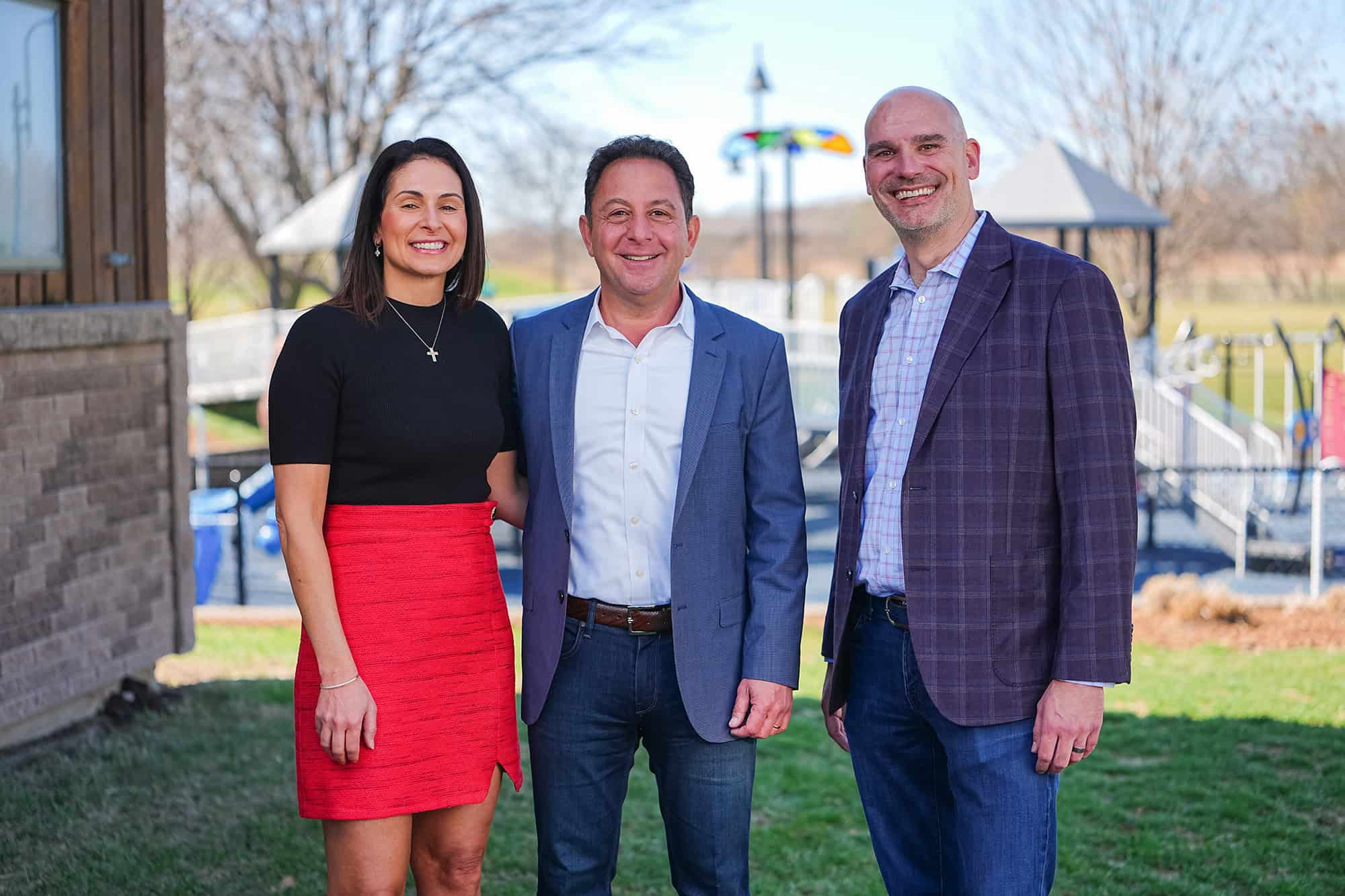 Veronica and Peter Mallouk, leaders of the Mallouk Family Foundation, stand with Marc Harrell, CEO and chief inclusion officer of Variety KC, at one of Variety KC's existing playgrounds; courtesy photo