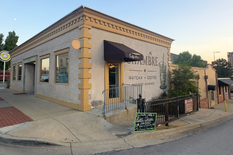 A "Live Music" sign in front of Chambre Coffee, the upper level of the 4010 Pennsylvania Ave. complex, directs customers to GreenHorn Bar & Grill; photo by Joyce Smith