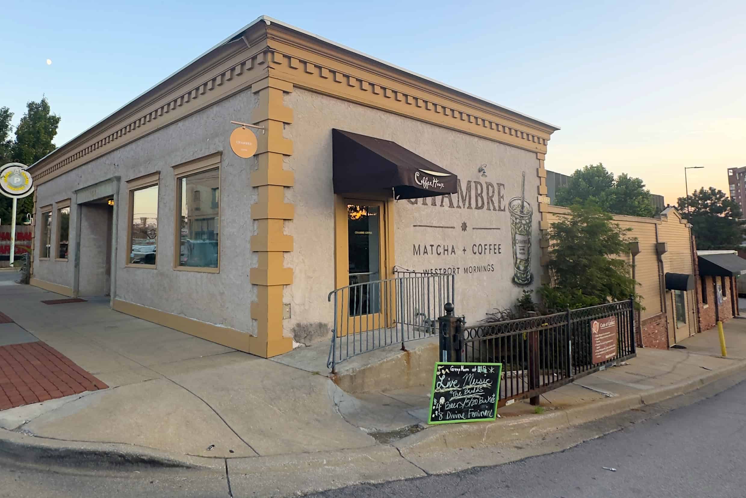 A "Live Music" sign in front of Chambre Coffee, the upper level of the 4010 Pennsylvania Ave. complex, directs customers to GreenHorn Bar & Grill; photo by Joyce Smith