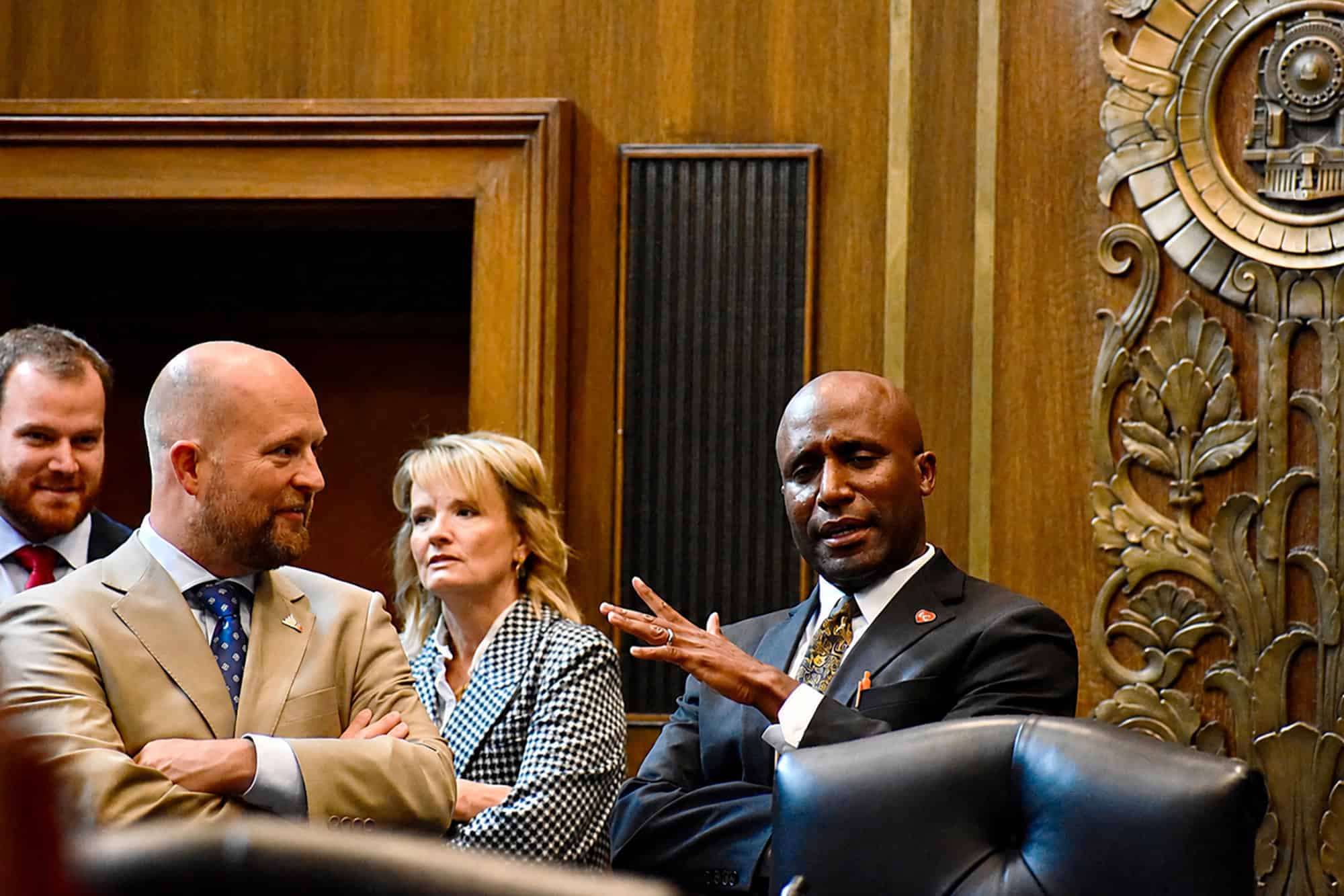 Mayor Quinton Lucas, right, talks with 2nd District Councilman Wes Rogers in Council Chambers before a critical vote on small business support in Kansas City; photo by Nikki Overfelt Chifalu, Startland News
