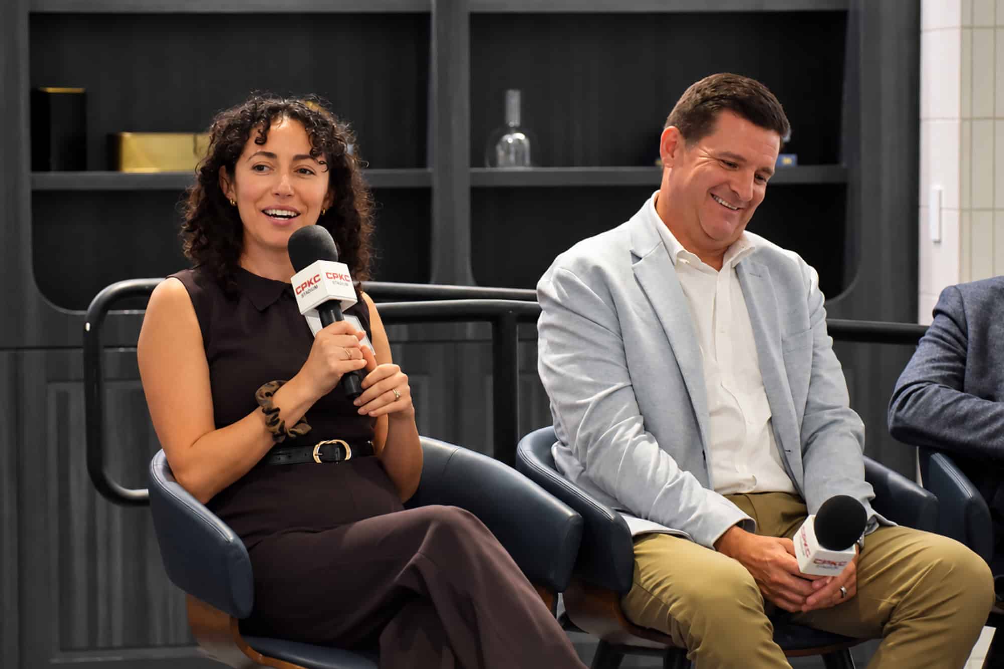 Julia Kanter, an expert in agentic AI and product experiences, shares a laugh with Ryan Shreeve, co-founder of TENEX.AI, during a Back2KC panel conversation at CPKC Stadium; photo by Taylor Wilmore, Startland News