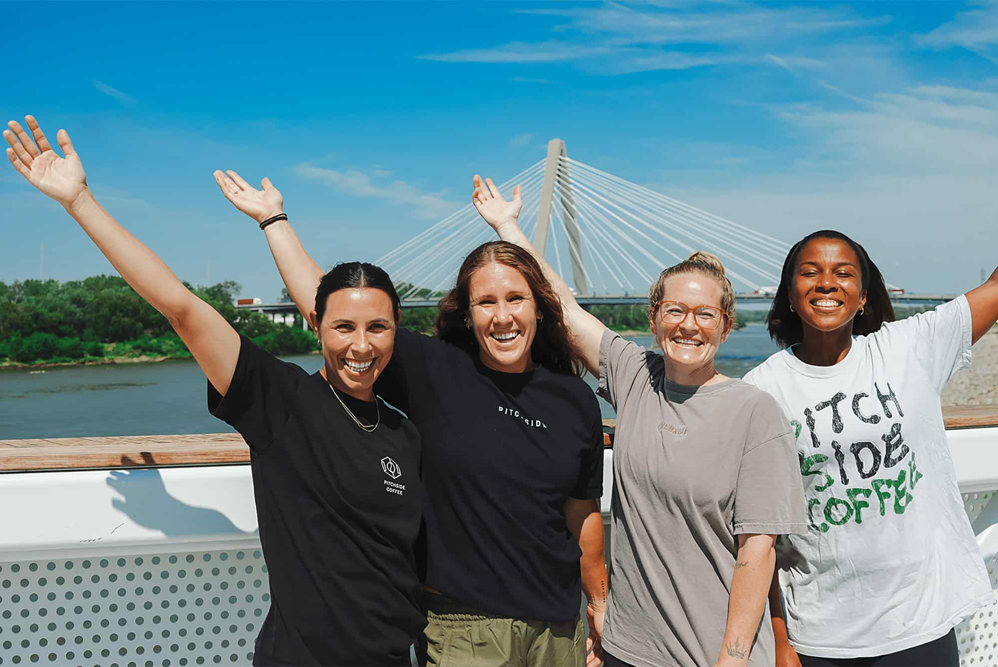 A promotional image featuring the co-founders of Pitchside Coffee at the riverfront near CPKC Stadium; photo courtesy of the Kansas City Current