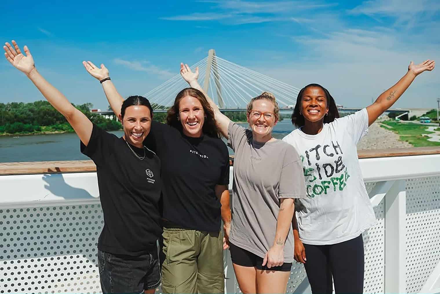 A promotional image featuring the co-founders of Pitchside Coffee at the riverfront near CPKC Stadium; photo courtesy of the Kansas City Current