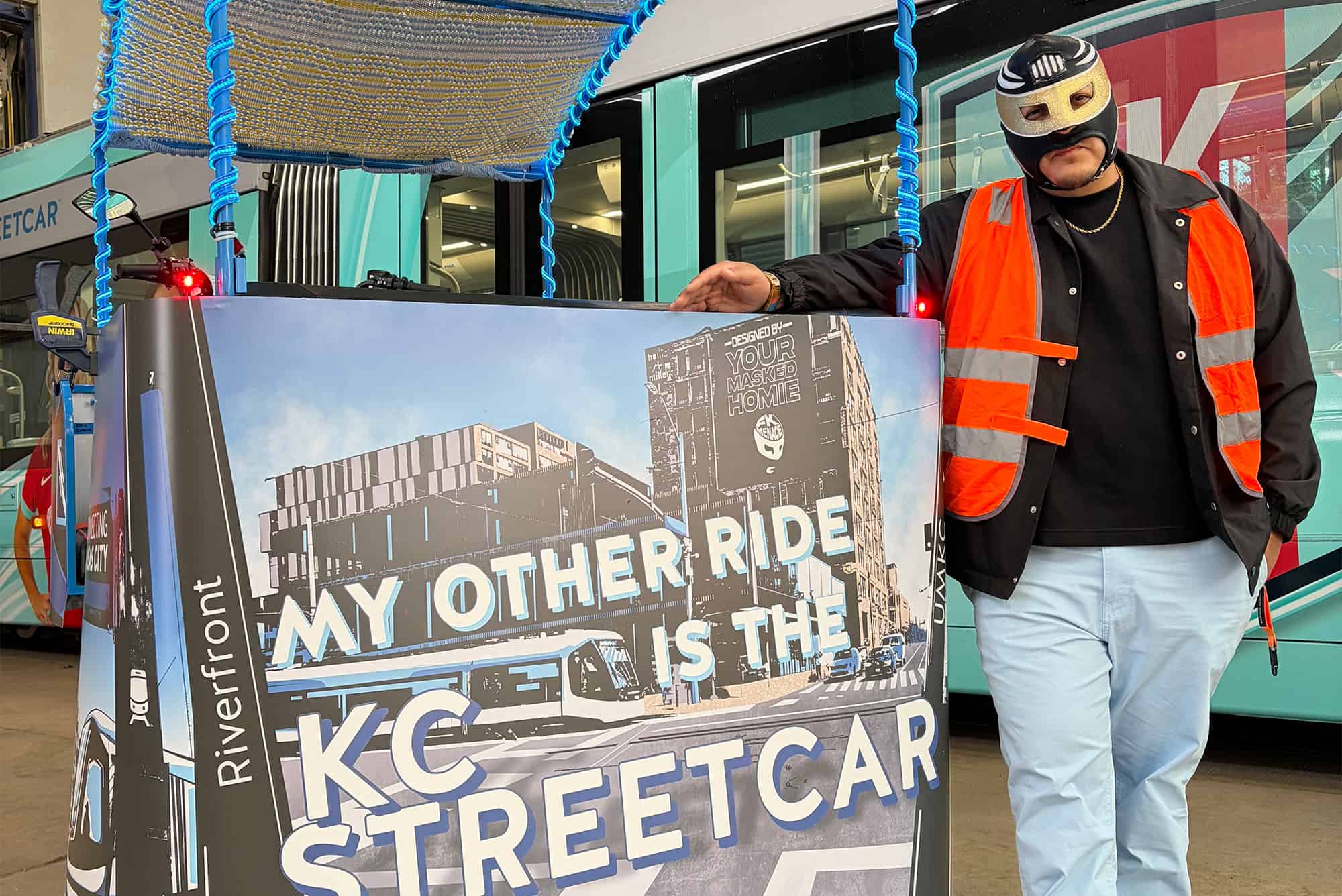 FK Menace stands with an EZ Pedicabs e-bike wrapped to reflect a connected transit partnership with KC Streetcar; photo courtesy of the KC Streetcar Authority