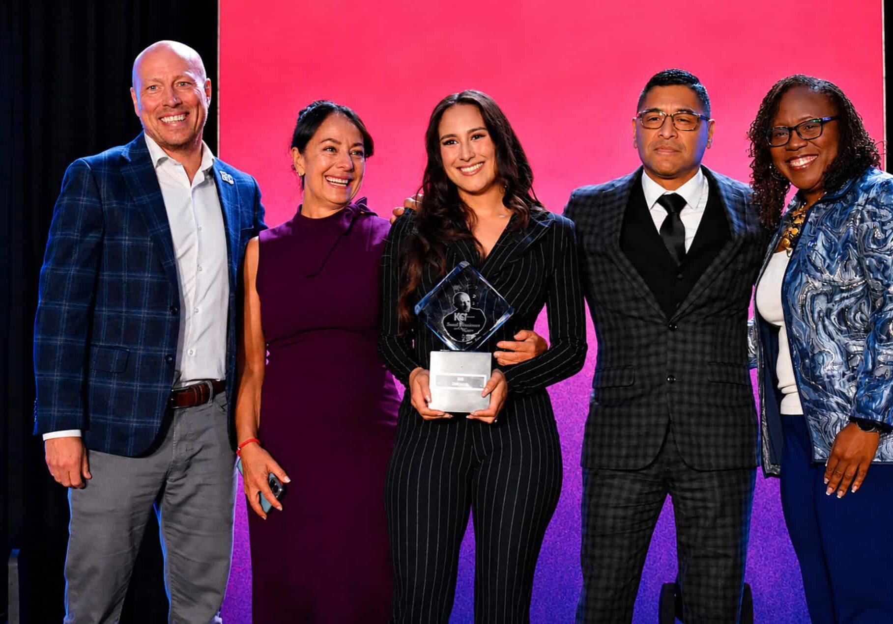 Miel Castagna-Herrera, Dulcinea Herrera, and Curtis Herrera, co-owners of Café Corazón, accept the Mr. K Award or Small Business of the Year from David Pruente, Greater Kansas City Chamber of Commerce, and Dr. DeAngela Burns-Wallace, Ewing Marion Kauffman Foundation, during the KC Chamber's Small Business Celebration luncheon; photo by Taylor Wilmore, Startland News 
