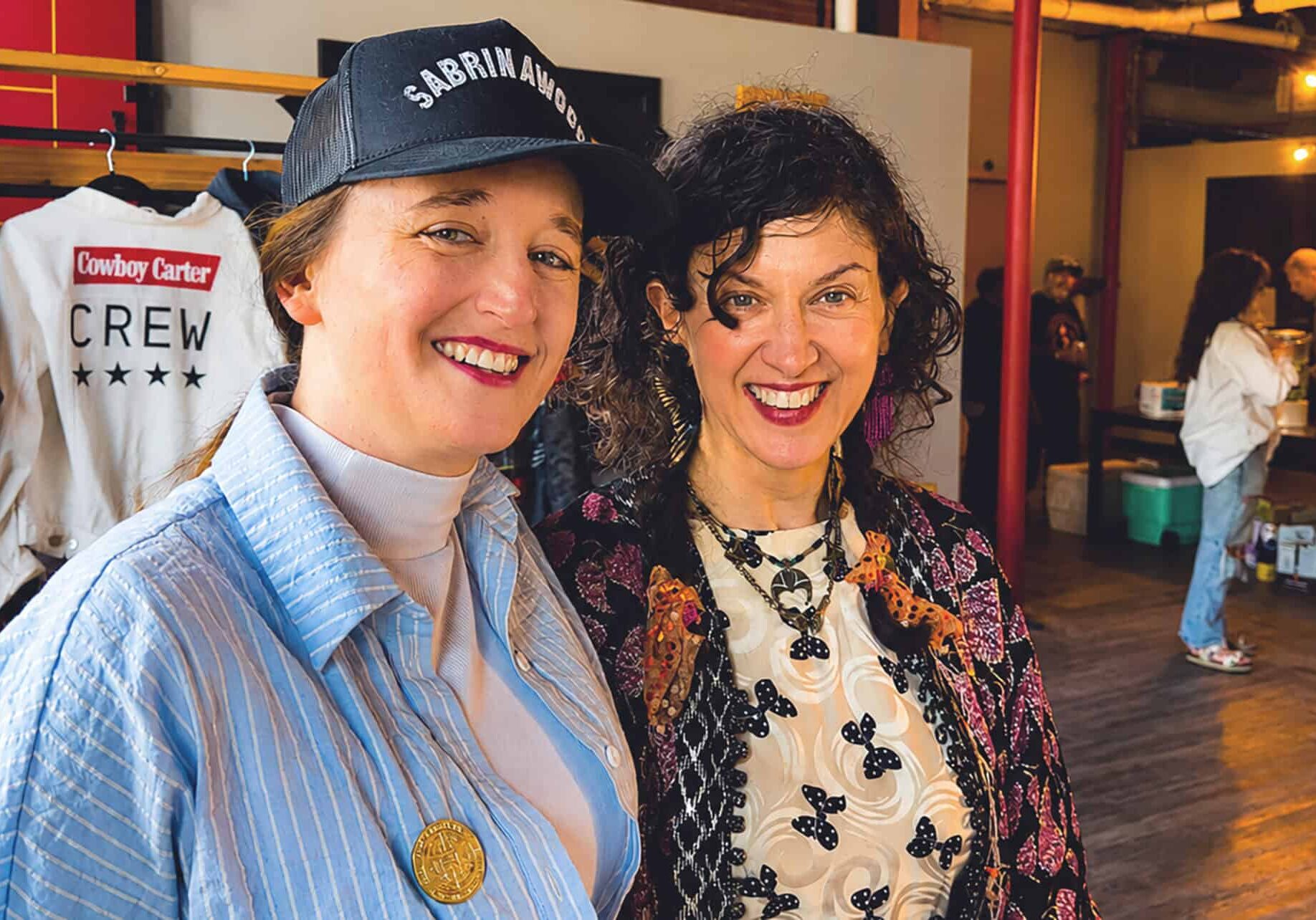 Paige Beltowski, owner of Cut & Sew Production KC, and Peregrine Honig, co-owner of Birdies, at a friends and family inside the new Cut & Sew space at 510 Delaware St. Both Beltowski and Honig are members of the inaugural Open Doors! cohort; photo by Joyce Smith
