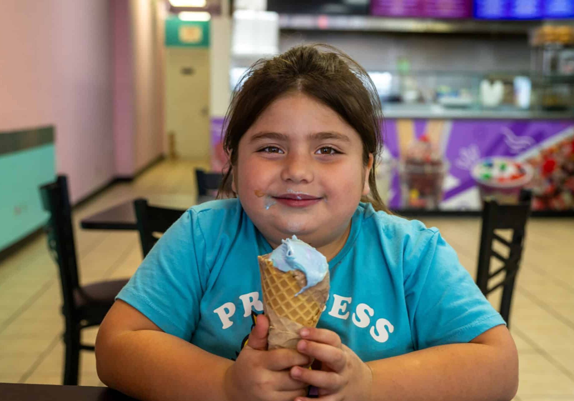 Yazmine Guerrero, 7, of St. Joseph, Missouri, enjoyed a bubblegum ice cream waffle cone recently at Frutopia, located at 3737 Independence Avenue in Kansas City, Missouri. Frutopia is a Mexican paleteria, ice cream shop, and grill; photo by Todd Feeback, Flatland